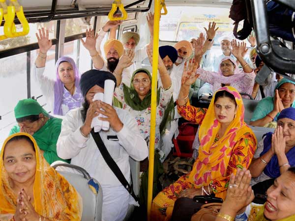 Sikh devotees shout religious slogans as they leave to board a special pilgrimage train bound for Pakistan