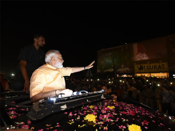 PM waving at people during roadshow