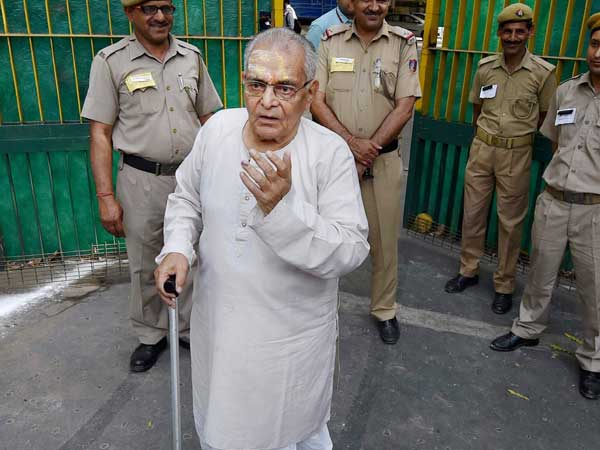 An elderly person leaves after casting his vote for MCD elections at a polling station in New Delhi.