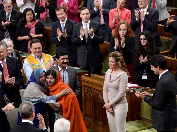 Pakistani activist and Nobel Peace Prize winner Malala Yousafzai, center, is hugged by her mother, Tor Pekai Yousafzai, as she's paid tribute in the House of Commons. Pakistani activist and Nobel Peace Prize winner Malala Yousafzai, center, is hugged by her mother, Tor Pekai Yousafzai, as she's paid tribute in the House of Commons.