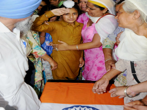 Paramjit Singh's son salutes coffin of his father