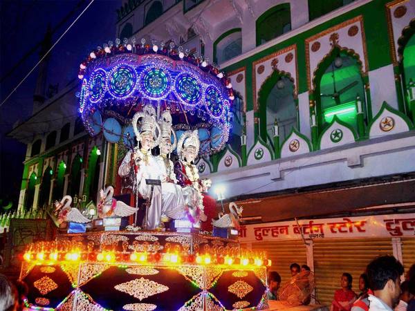 Artists dressed as Lord Rama, Sita and Laksmana during a Dussehra procession