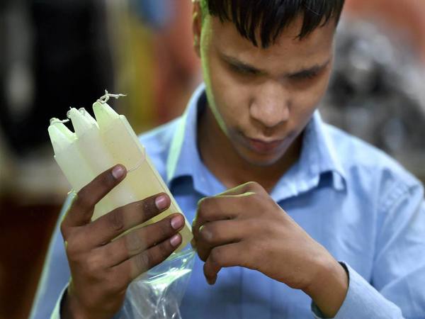 Blind student packing candles 