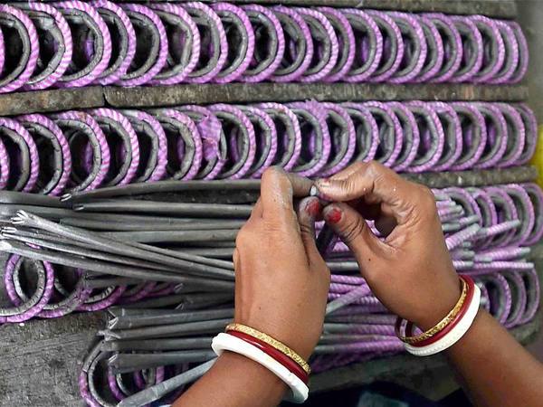A woman making fire crackers A woman making fire crackers