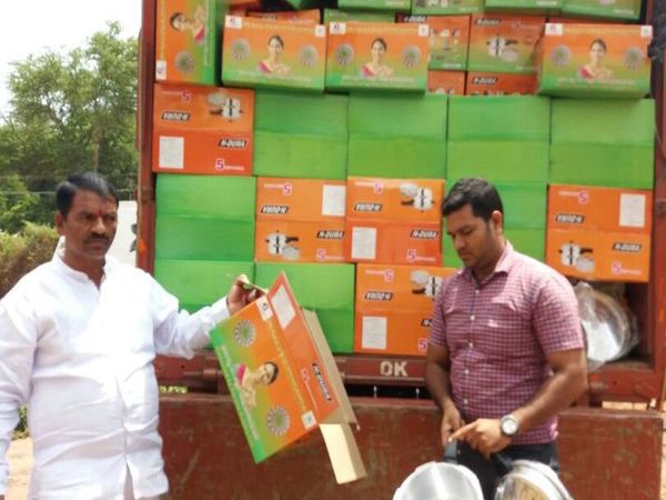A truck carrying pressure cookers with pictures of Laxmi Hebbalkar. Courtesy: ANI news A truck carrying pressure cookers with pictures of Laxmi Hebbalkar. Courtesy: ANI news