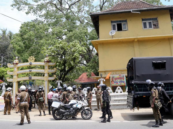 Sri Lankan police officers stand out side a vandalized Buddhist Temple in Poojapitiya, in central Sri Lanka. Sri Lankan police officers stand out side a vandalized Buddhist Temple in Poojapitiya, in central Sri Lanka.