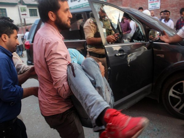 The police bodyguard of Shujaat Bukhari being carried away