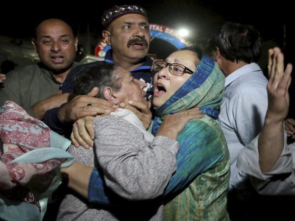 Relatives and friends of Shujaat Bukhari crying inside a police control room in Srinagar