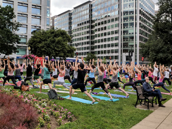 People gather to perform yoga after office hours