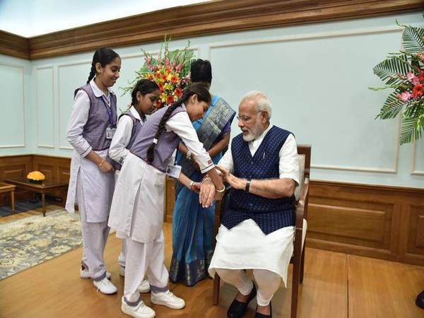 School girls tie Rakhi to PM Modi