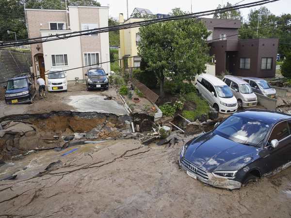 Cars stuck in mud covered road after earthquake