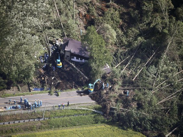 Police search missing persons at the site of a landslide after an earthquake in Atsuma town