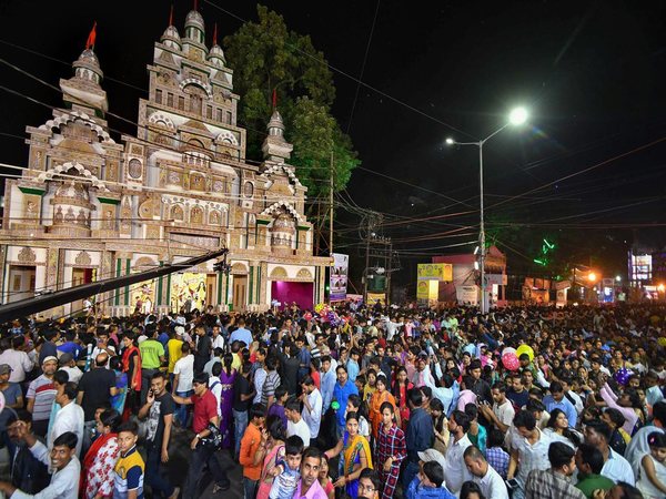 Devotees walk around the pandal