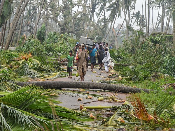Locals walk as the cyclone hit the village