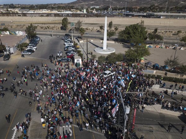 A group of migrants gathered at the Chaparral border crossing in Tijuana, Mexico A group of migrants gathered at the Chaparral border crossing in Tijuana, Mexico