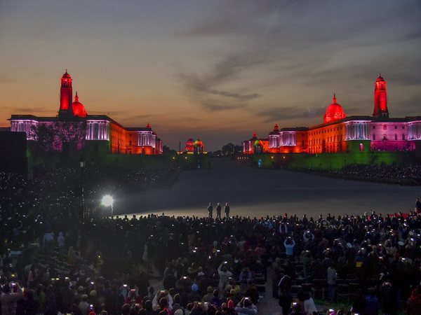 Members of the audience wave their mobile phones to add light to the illuminated Raisina Hills