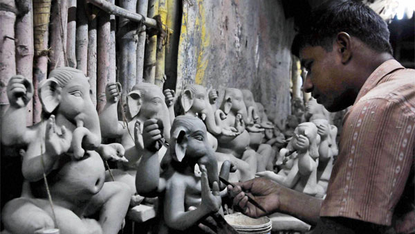 An artist making clay idol of Lord Ganesha for the upcoming Ganesh Chaturthi festival An artist making clay idol of Lord Ganesha for the upcoming Ganesh Chaturthi festival