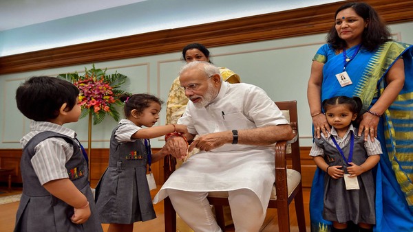 Children tie 'rakhi' on the wrist of PM Children tie 'rakhi' on the wrist of PM