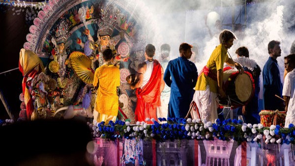 A grand procession soaked in the soul rendering rhythms of dhak and enveloped with the fragrant of dhuno 