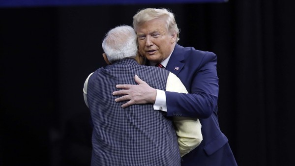 Prime Minister Narendra Modi and President Donald Trump embrace after introductions during the Howdi Modi event