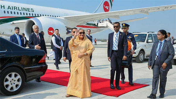 Sheikh Hasina waves upon her arrival at the airport