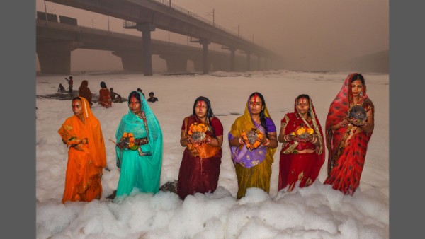 Devotees offering prayers surrounded by toxic foam