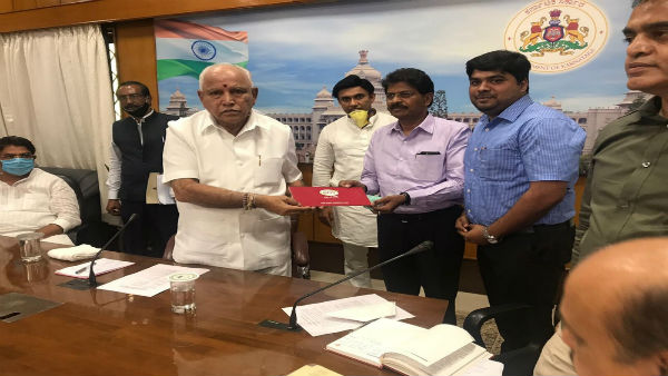 G R Balasubramaniam, Founder and Chairman, GRB Dairy Foods Pvt. Ltd handing over cheque to B S Yediyurappa