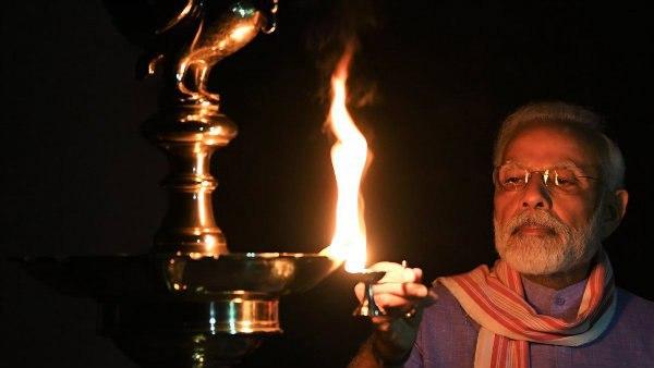 Narendra Modi lights a lamp Narendra Modi lights a lamp