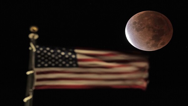 Lunar eclipse sets beyond US flag