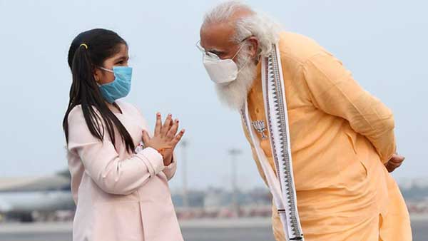 A young girl greets PM Modi