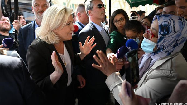 Macron, Le Pen lock horns over Islamic headscarf