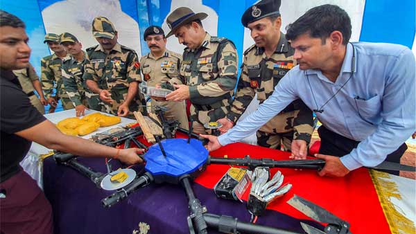 Border Security Force DIG Bhupinder Singh along with other personnel displays the drone from Pakistan that was shot down near Bharopal village of Amritsar district