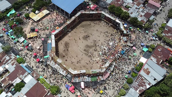 In this image taken from video, spectators agglomerate around the wooden stands that collapsed during a bullfight in El Espinal, Tolima state, Colombia In this image taken from video, spectators agglomerate around the wooden stands that collapsed during a bullfight in El Espinal, Tolima state, Colombia