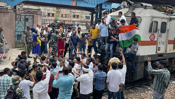 Members of Indian Youth Congress (IYC) stop a train at Shivaji Bridge as they protest over EDs probe against Rahul Gandhi in the National Herald case and Centres Agnipath scheme, in New Delhi Members of Indian Youth Congress (IYC) stop a train at Shivaji Bridge as they protest over EDs probe against Rahul Gandhi in the National Herald case and Centres Agnipath scheme, in New Delhi