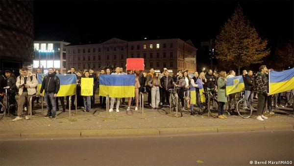 The two groups of protesters, one of them berating Ukrainian refugees and another one showing their support, traded insults