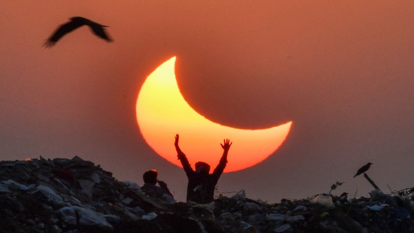 Stargazers spellbound as partial eclipse arcs across India 