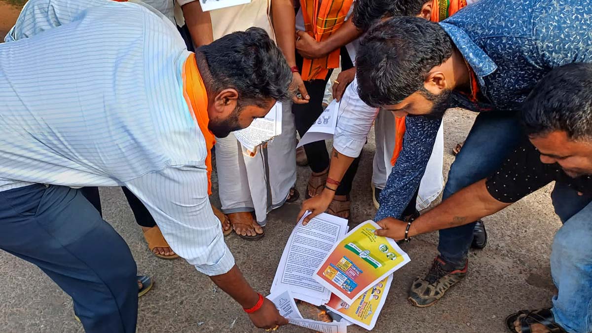 Bajrang Dal workers burn copies of Karnataka Congress manifesto during a protest in Udupi Bajrang Dal workers burn copies of Karnataka Congress manifesto during a protest in Udupi