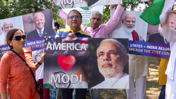 Indian community members hold posters of Prime Minister Narendra Modi during Unity rally, ahead of his visit to the US, in Washington
