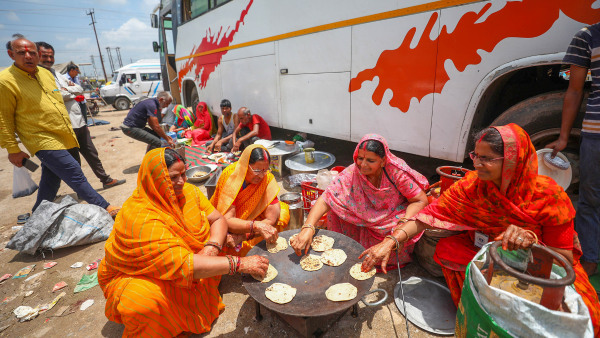 Stranded pilgrims prepare food after the Amarnath Yatra was temporarily suspended due to bad weather, in Jammu Stranded pilgrims prepare food after the Amarnath Yatra was temporarily suspended due to bad weather, in Jammu