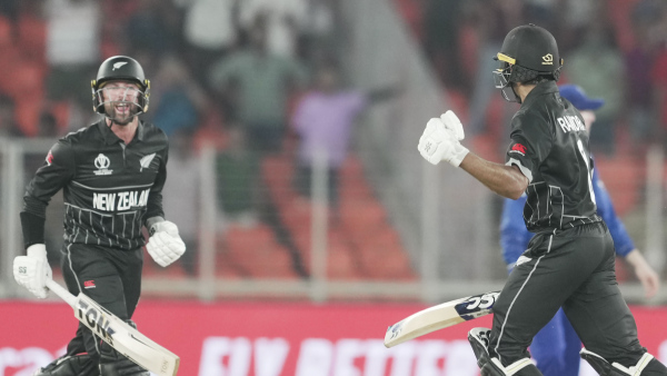 New Zealands batters Devon Conway and Rachin Ravindra celebrate after winning their ICC Mens Cricket World Cup match against England, at Narendra Modi Stadium in Ahmedabad