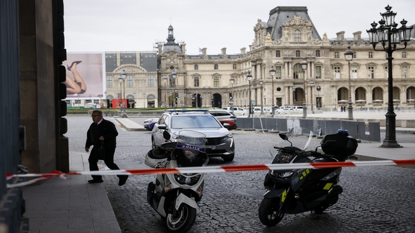 Police officers stand guard outside the Louvre Museum as people are evacuated after it received a written threat, in Paris, Saturday (PTI Photo)