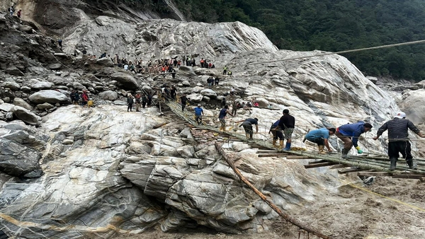 A temporary bamboo bridge being constructed at Chungthang connecting it to Pegong days after flash floods, in Mangan district, Sikkim (PTI Photo)