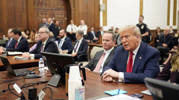 Former President Donald Trump sits in the courtroom with his legal team before the continuation of his civil business fraud trial at New York Supreme Court