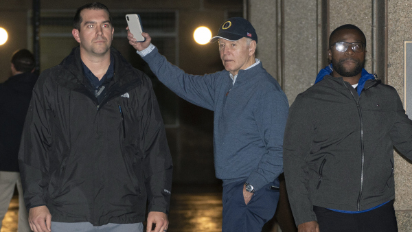 President Joe Biden waves as he leaves his campaign headquarters in Wilmington, Del., Sunday, Dec. 17, 2023, before an incident where a car plowed into a parked SUV that was part of Bidens motorcade
