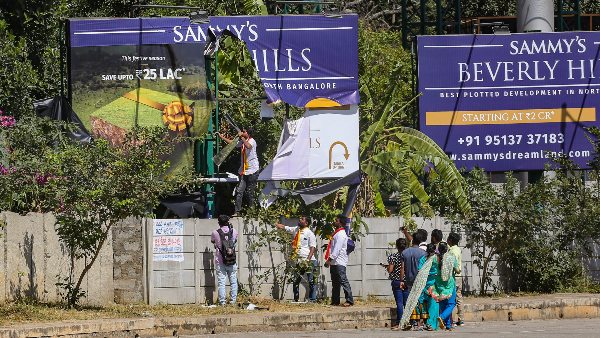 A billboard being vandalised by Karnataka Rakshana Vedike (Narayana Gowda faction) activists, in Bengaluru
