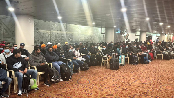 Passengers of a charter plane, which was grounded in France for four days over suspected human trafficking, arrive in Mumbai