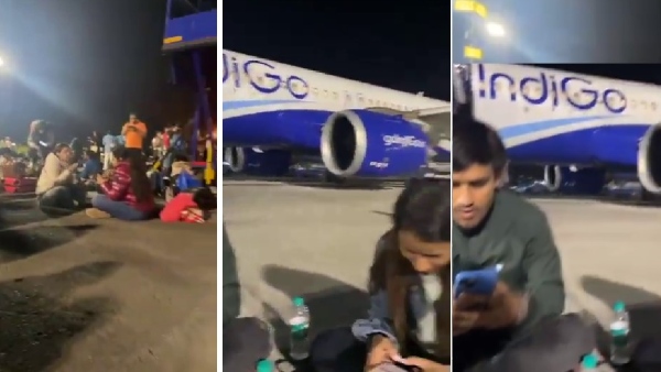 Exhausted Passengers Eating Food On Tarmac, Next To Plane