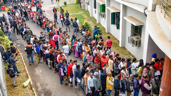 Aspirants stand in queue to enter the examination centre