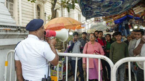 Security personnel restricts entry of visitors at the Indian Museum following a bomb threat, in Kolkata
