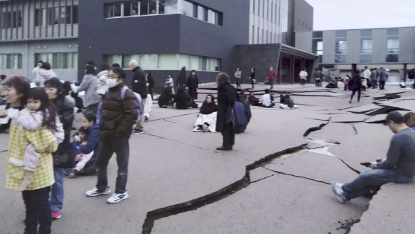 Cracks are seen on the ground in Wajima, Ishikawa prefecture, Japan Monday, Jan. 1, 2024, following an earthquake. Japan issued tsunami alerts Monday after a series of strong quakes in the Sea of Japan